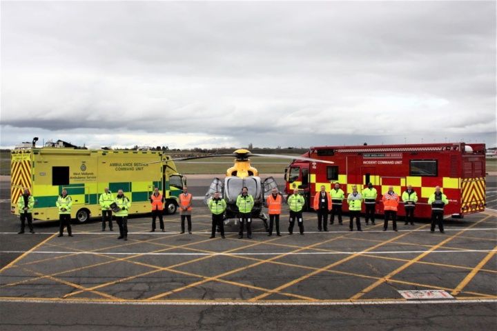 National Police Air Service, West Midlands Fire Service and West Midlands Ambulance Service staff stood in a line in front of each services vehicles