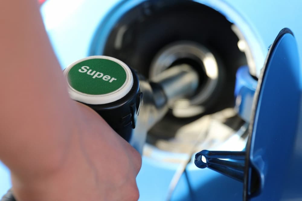 A close up of a petrol pump filling a car tank
