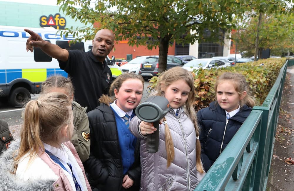 Children being taught about road safety by a firefigher