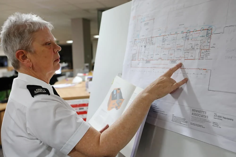 A fire safety officer looking over building plans