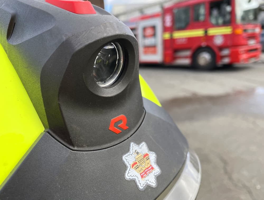 A close up of the West Midlands Fire Service crest on a firefighters helment