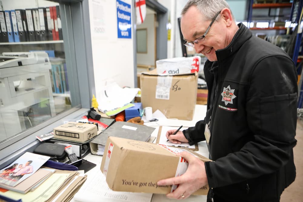 Member of our warehouse and distribution team checking a package
