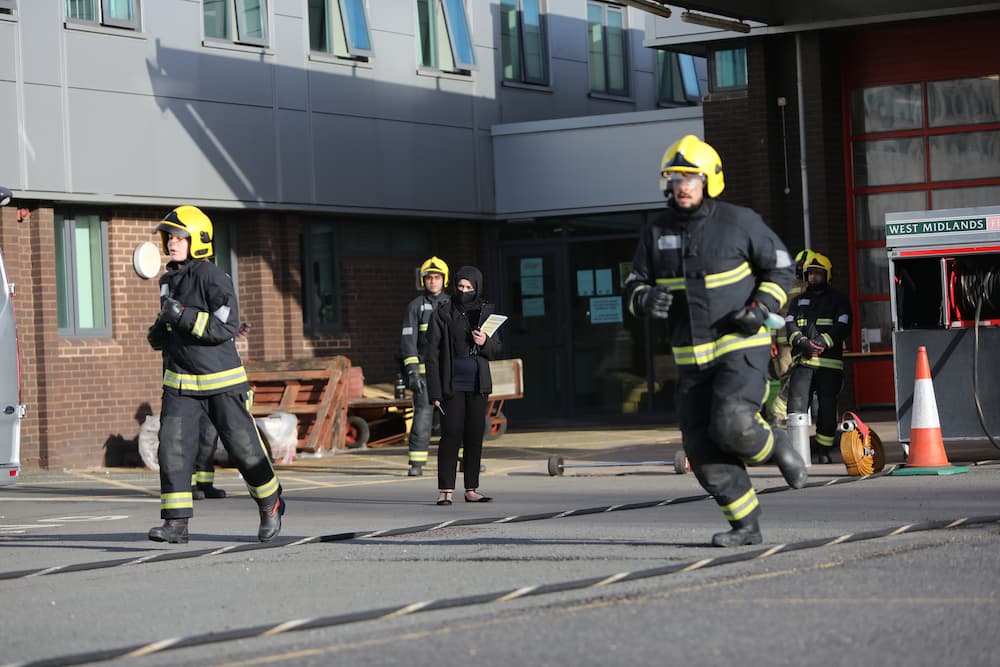 A firefighter candidate running a coned area