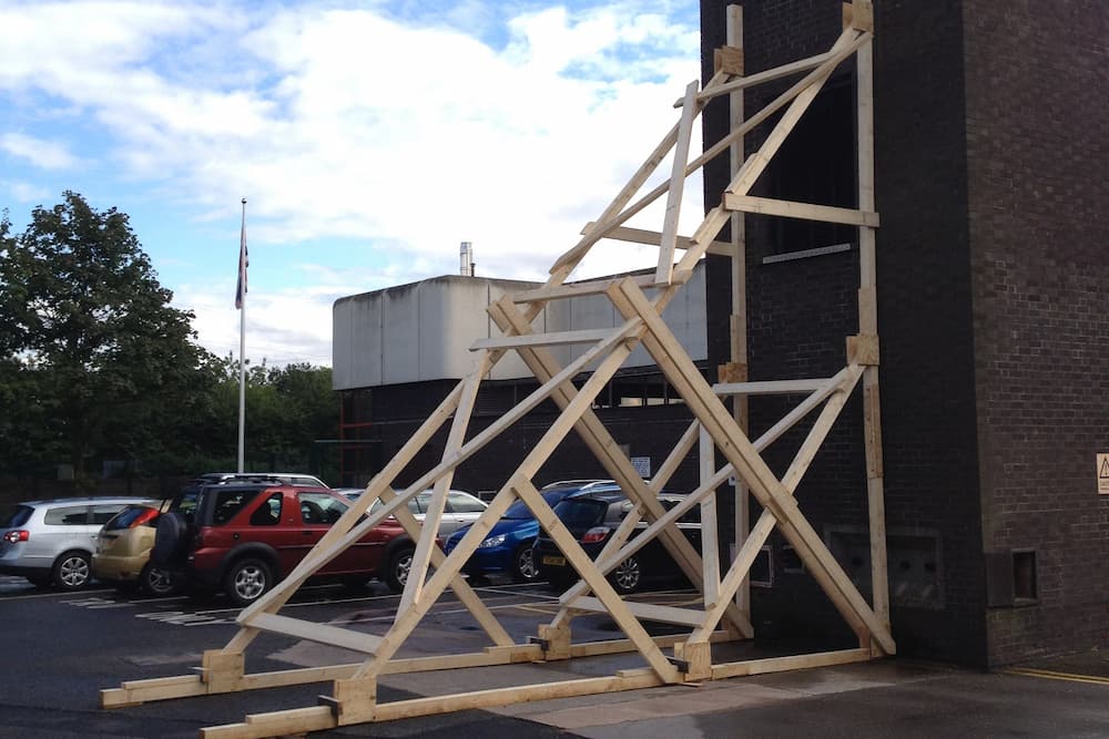 A wooden shoring structure holding up a building