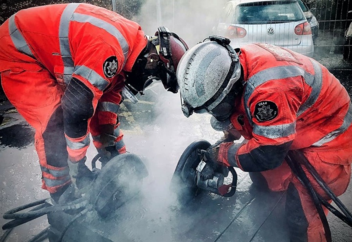 Two firefighters cutting metal