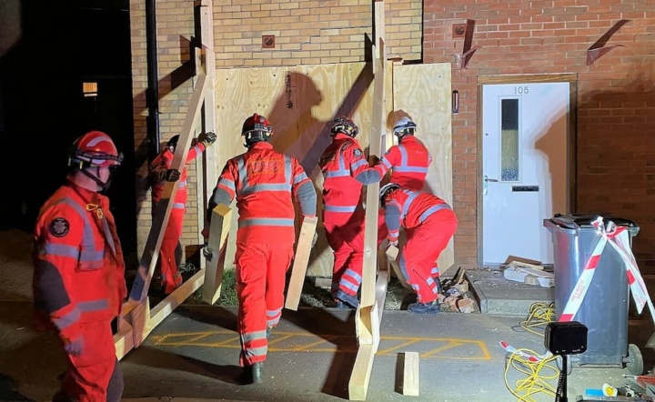 Firefighters shore up an unsafe building