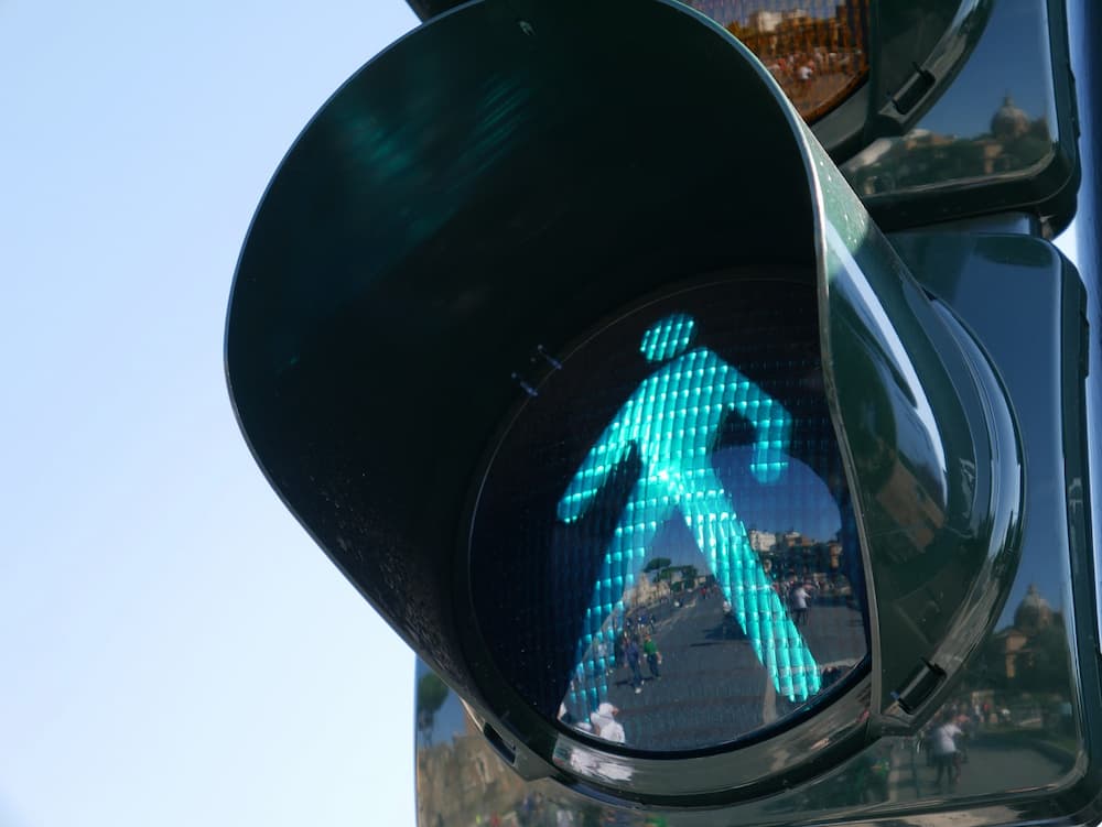 A green man showing on traffic light signal