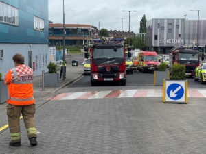 Hazardous materials officer stood near a fire engine outside Sainsburys.