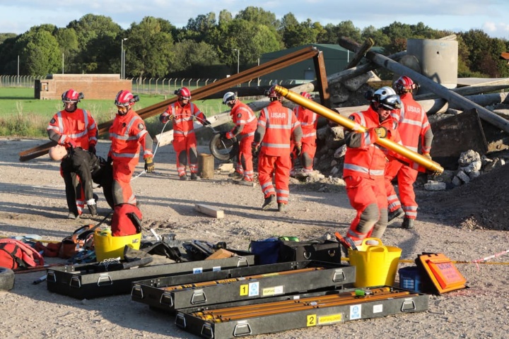 Several search and rescue teams doing duties at a rescue training site.
