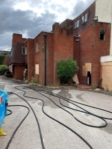 Fire hoses laid out at the rear of the hotel building
