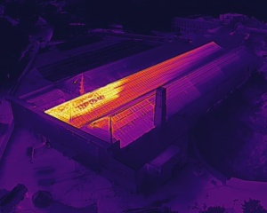 Drone image in thermal image mode showing heat pattern on roof