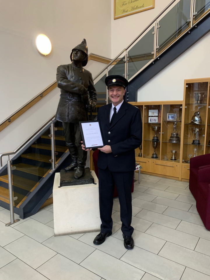 Crew Commander Phil Shee holding his CFO Commendation certificate