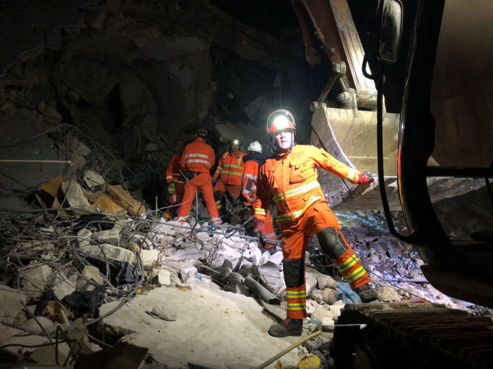UKISAR personnel working in area surrounded by rubble