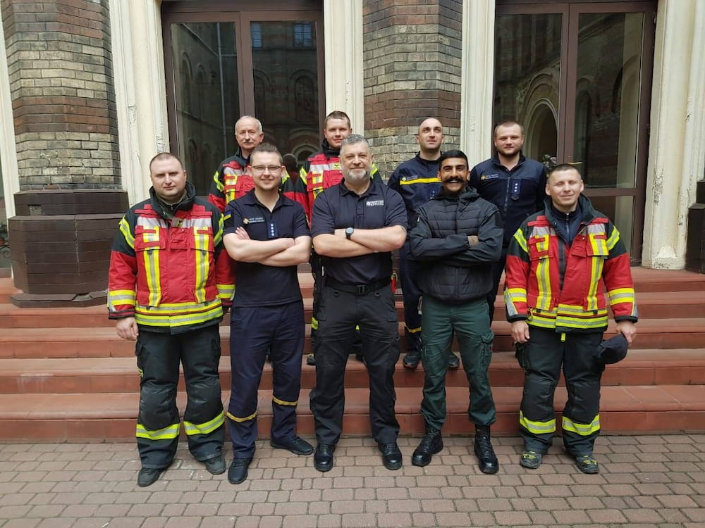 Firefighter Sahfan Khan pictured with a group of other instructors and emergency service colleagues in Ukraine.
