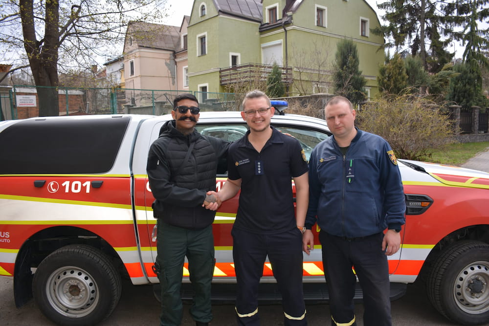 Firefighter Sahfan Khan pictured with two other emergency service colleagues from Ukraine.