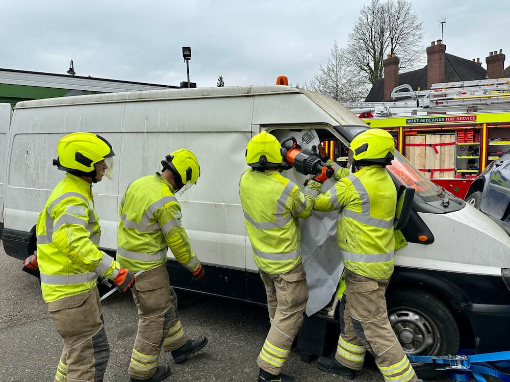 Fire crews use equipment to gain entry to a white van during a training exercise