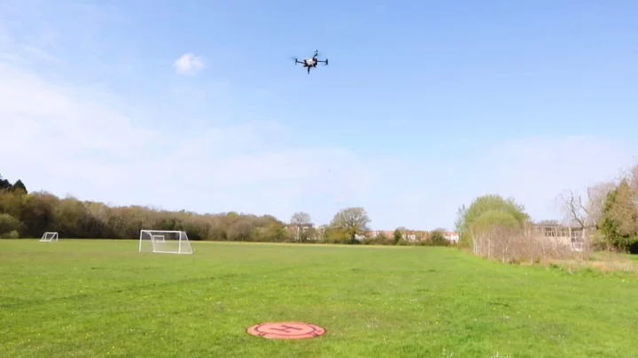 A drone taking off in a park
