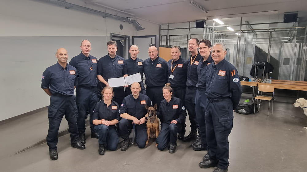 WMFS members of the UKISAR team stood together with their reclassification certificate.